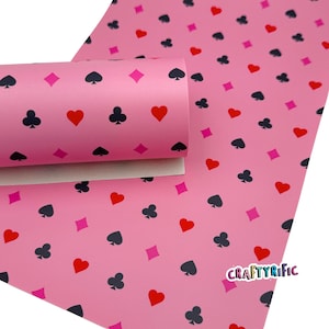 May include: Pink playing card-themed faux leather sheet with a repeating pattern of hearts, spades, clubs, and diamonds. The sheet is rolled up, revealing the white backing. The CraftyRific logo is visible.