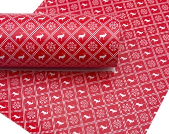 May include: Red and white patterned faux leather sheet with a repeating design of snowflakes and reindeer. The sheet is rolled up and the pattern is visible on both the rolled and unrolled portions.