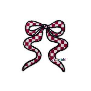 May include: Embroidered bow patch with a red and white checkered pattern. The bow has black outlines and long, flowing tails. The text "CRAFTYRIFIC" is visible on the lower right tail. This patch is suitable for various craft projects.