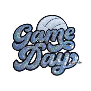 May include: A sparkly, light blue "Game Day" design with a volleyball graphic. The text is in a script font with a black outline and is covered in iridescent sequins. The volleyball is white with a dotted pattern.