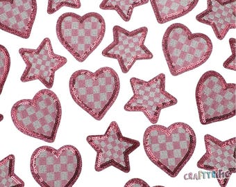 May include: Pink and white checkered heart and star shapes with a glittery finish. These iron-on patches are perfect for adding a touch of sparkle to clothing, bags, and other accessories.
