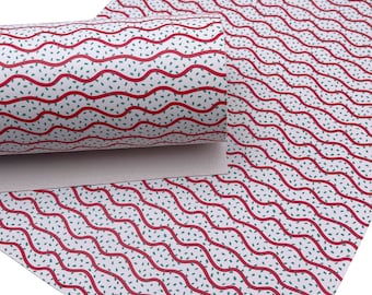 May include: White patterned paper with red wavy lines and small green speckles. A roll of the same paper is visible, showing the pattern in a rolled format. The design is repeated across the surface.