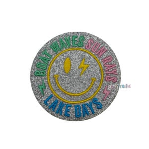 May include: A silver glitter iron-on patch with a yellow smiley face, a lightning bolt, and the text "Boat Waves Sun Rays Lake Days" in green, pink, and blue.