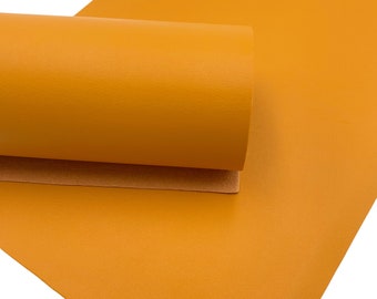 May include: A sheet of bright yellow faux leather with a textured surface. The leather is rolled up, showing the underside of the material.