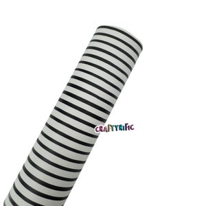 May include: A roll of white material with black horizontal stripes. The material is tightly rolled and angled towards the upper left corner. The text "CraftyRific" is printed in the lower right corner.
