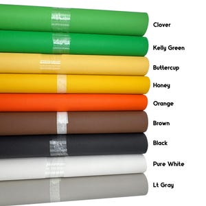 May include: A stack of colorful fabric rolls in shades of green, yellow, orange, brown, black, white, and gray. Each roll is labeled with its color name: Clover, Kelly Green, Buttercup, Honey, Orange, Brown, Black, Pure White, and Lt Gray.