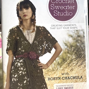 May include: Crochet Sweater Studio DVD featuring Robyn Chachula. The cover shows a woman wearing a green crochet sweater with a brown belt and a flower accent. The text on the cover reads "Crochet Sweater Studio" and "Creating garments that suit your shape".