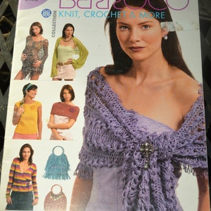 May include: A magazine cover featuring a woman wearing a lavender crochet shawl with a decorative brooch. The cover also displays various knit and crochet designs, including shawls, tops, and bags. The magazine title is "Berroco Knit, Crochet & More Collection."