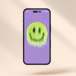 May include: A smartphone displaying a fuzzy green smiley face on a purple background. The time on the screen is 8:30.