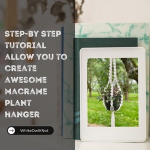 May include: A white macrame plant hanger with a potted plant hanging from it. The hanger is in focus and the plant is slightly out of focus. The background is a blurred image of a green forest. The text "WhiteOwlKnot" is visible in the bottom left corner of the image.