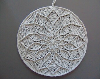 May include: A white crocheted round doily with a starburst design.