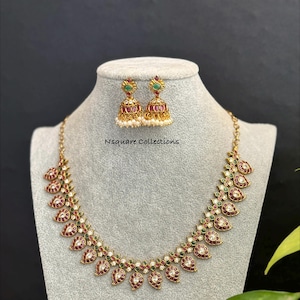 May include: A set of three ceramic mugs with a speckled, matte finish. The mugs are in shades of cream, light gray, and dark gray. Each mug has a simple, minimalist design and a rounded handle.