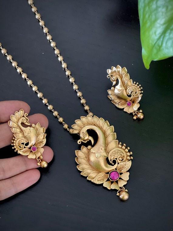 Peacock design gold locket discount