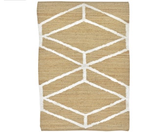 Alfombra Dhurrie de yute tejida a mano, vegana pura, con diseño geométrico en marrón y blanco.