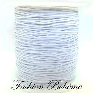 May include: A spool of white elastic cord. The cord is tightly wound, creating a cylindrical shape. The text "Fashion Boh&egrave;me" is written in cursive at the bottom of the image.