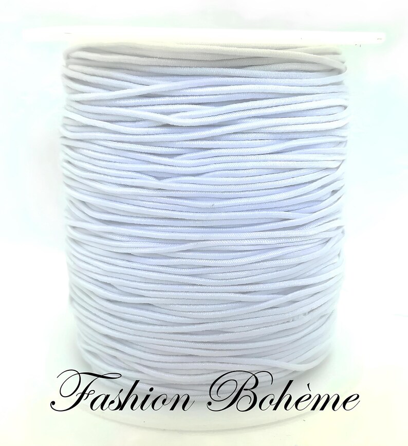 May include: A spool of white elastic cord. The cord is tightly wound, creating a cylindrical shape. The text "Fashion Boh&egrave;me" is written in cursive at the bottom of the image.