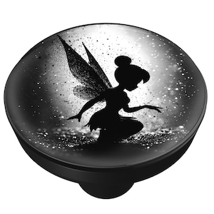 May include: A black and white decorative knob featuring a silhouette of a fairy with detailed wings. The fairy is set against a speckled, glittery background. The knob has a rounded top and a black base.