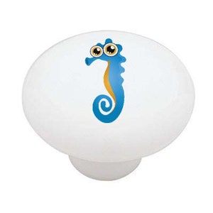 May include: A blue and yellow cartoon seahorse with big eyes. The seahorse is on a white ceramic knob.