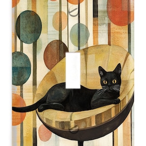 May include: Decorative light switch cover featuring a black cat lounging in a mid-century modern chair. The background has a retro design with colorful circles and vertical lines. The switch plate is rectangular with a single switch opening.
