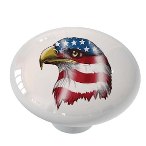 May include: Ceramic knob with a white background and a colorful image of an eagle with the American flag on its head.
