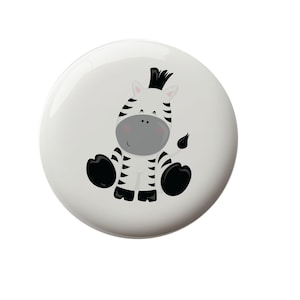 May include: A black and white zebra with a black mane and tail, sitting on a white background. The zebra has a cute, cartoon-like expression.