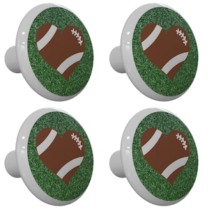 May include: Set of four white ceramic cabinet knobs with a green glitter background and a brown football shaped heart with white laces.