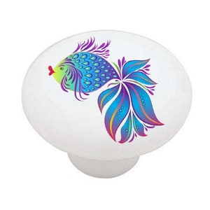 May include: A colorful ceramic knob with a blue, purple, and green fish design. The fish has a yellow body and a red mouth.