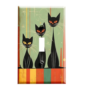 May include: A light switch cover featuring a retro design with three black cats on a green and orange striped background.