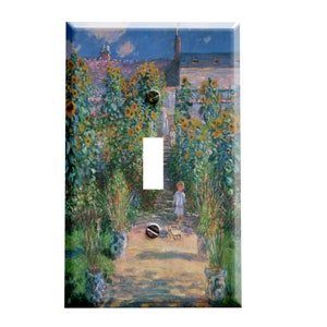 May include: A light switch cover featuring a painting of a garden path lined with sunflowers. A young child in a white shirt walks along the path.