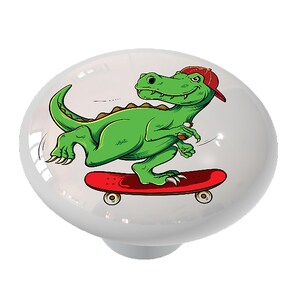 May include: A green dinosaur wearing a red baseball cap is skateboarding. The dinosaur is on a red skateboard with black wheels. The background is white.