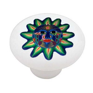 May include: A colorful ceramic knob with a blue, green, and orange sun face design. The sun has a human face with closed eyes and a red mouth.