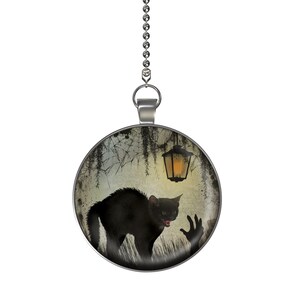 May include: A black cat with glowing red eyes stands in a spooky forest scene with a lantern hanging overhead. The image is printed on a round silver pendant with a silver chain.