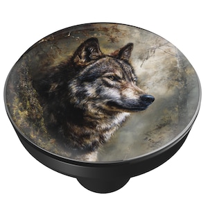 May include: A black and silver round decorative knob featuring a detailed image of a wolf's head. The wolf is depicted in shades of brown, gray, and black, set against a blurred forest background. The knob has a glossy finish and a rounded shape.