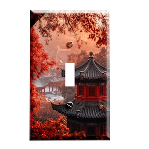 May include: A light switch cover featuring a photograph of a traditional Chinese pagoda with red accents, surrounded by autumn foliage.