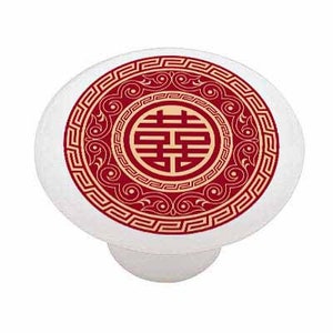 May include: A white ceramic knob with a red and gold Chinese double happiness symbol in a circular design. The symbol is surrounded by a red and gold border.