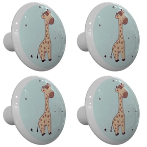 May include: Four ceramic knobs with a light blue background and a cartoon giraffe illustration. The giraffe is brown with a light brown spot pattern.