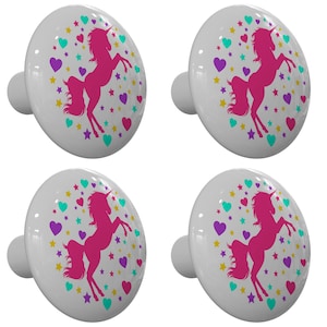 May include: Four white ceramic cabinet knobs with a pink unicorn silhouette surrounded by yellow, teal, and purple hearts and stars.