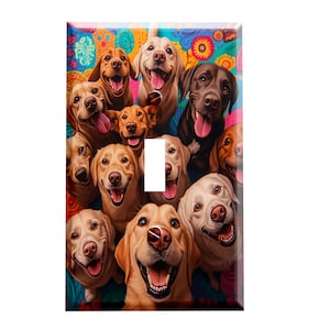 May include: A decorative light switch cover featuring a vibrant, colorful background with a collage of smiling dogs. The dogs are various breeds and colors, including golden, brown, and black. The switch plate has a glossy finish.