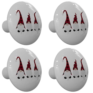 May include: Set of four white ceramic cabinet knobs with a red and black plaid gnome design. Each knob features three gnomes with white beards and red hats.