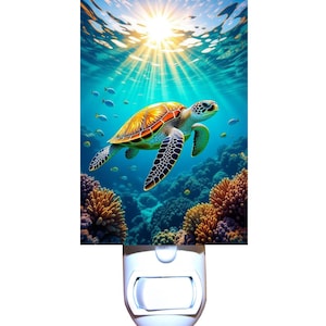 May include: A decorative night light featuring an underwater scene with a sea turtle swimming near coral. The turtle has a yellow and orange shell with black and white flippers. The background shows sunlight filtering through the water.