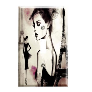 May include: A decorative light switch cover featuring a black and white illustration of a woman, the Eiffel Tower, and pink floral accents. The design has a vintage, Parisian theme.