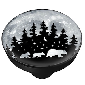 May include: Black and white graphic of a bear family walking through a forest under a moonlit sky. The design features silhouettes of pine trees, stars, and a crescent moon. The image is on a black, round base.