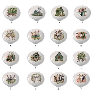 May include: Set of 16 ceramic knobs featuring various farm-themed illustrations. The knobs are white with a glossy finish and feature images of animals, farmhouses, and tractors.
