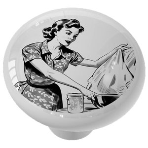 May include: Black and white illustration of a woman in a floral dress doing laundry. She is holding a piece of clothing over a bowl and a can is on the counter.