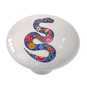 May include: A white ceramic knob with a colorful floral snake design. The snake is blue with red, yellow, pink, and green flowers.