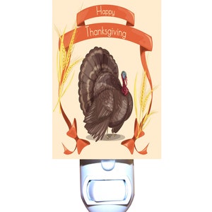 May include: A white night light with a beige background image of a turkey with a red ribbon that says "Happy Thanksgiving".