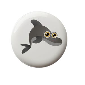 May include: A gray cartoon dolphin with big, round, yellow eyes. The dolphin is swimming to the right and has a white background.