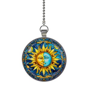 May include: A silver chain with a round pendant featuring a stained glass design of a sun and moon with blue, yellow, and gold colors.