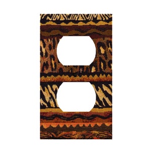 May include: A brown, black, and gold patterned outlet cover with two cutouts for electrical outlets.