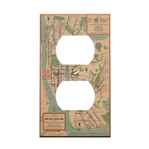 May include: A decorative light switch cover featuring a vintage map of the New York City subway system. The map is in shades of brown, green, and blue, with two oval cutouts for the outlets. The cover includes text from the Union Dime Savings Bank.